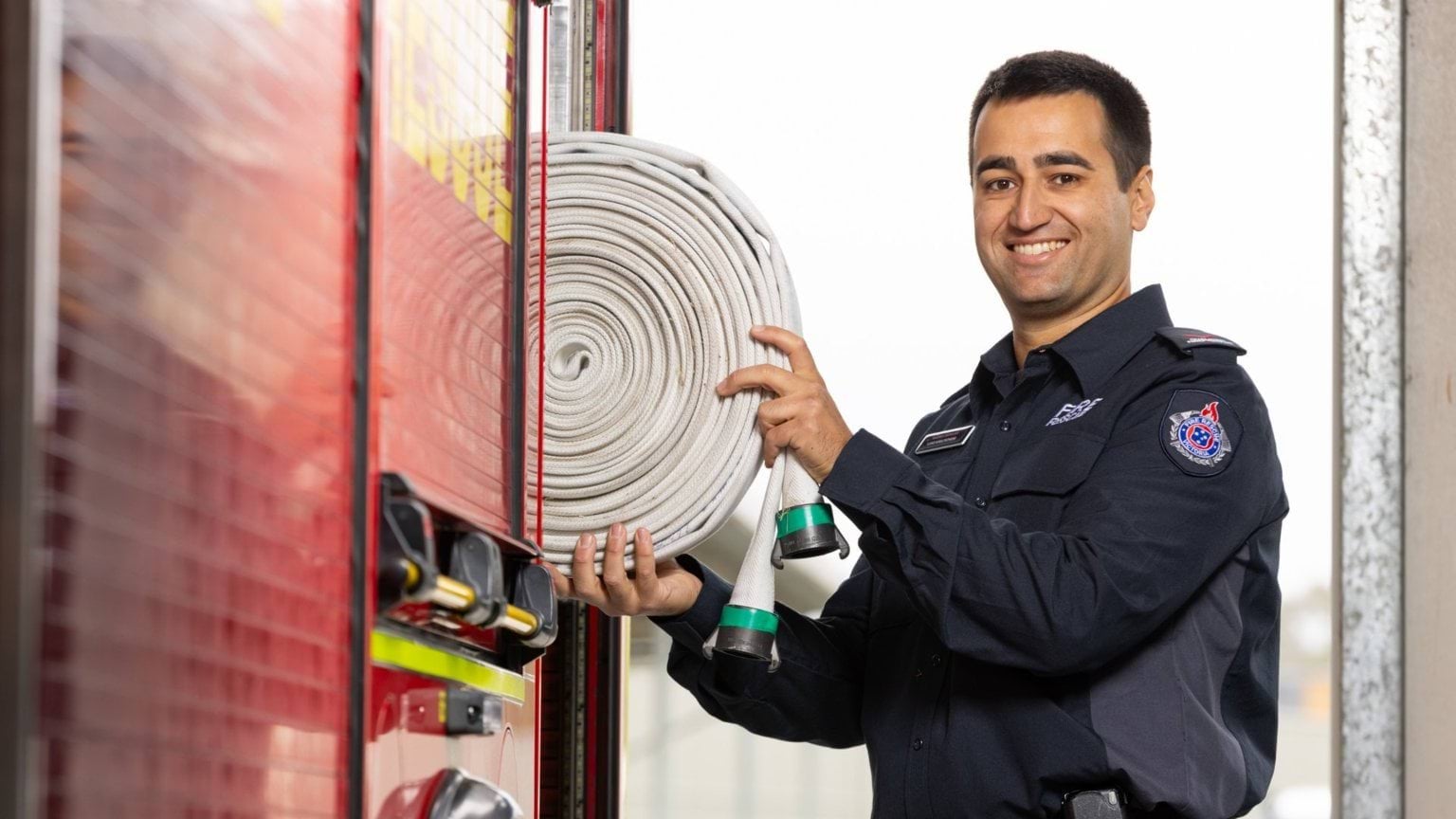 Male firefighter with hose
